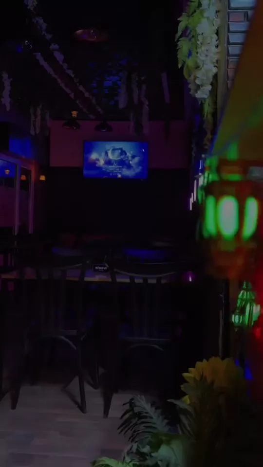Interior of Break Time Coffee Shop lit with neon